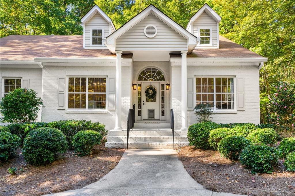 16218 Henderson Road Milton, GA 30004 - Photo 10 of 70 a front view of a house with a yard