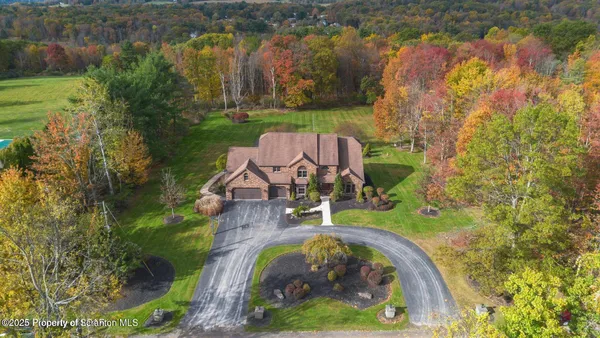 an aerial view of a house with garden space and lake view