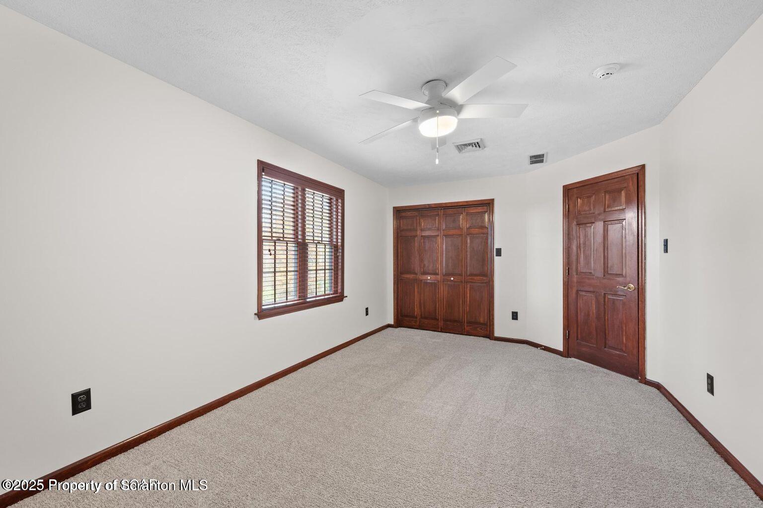 1266 Ryman Road Dallas, PA 18612 - Photo 19 of 73 an empty room with windows and closet