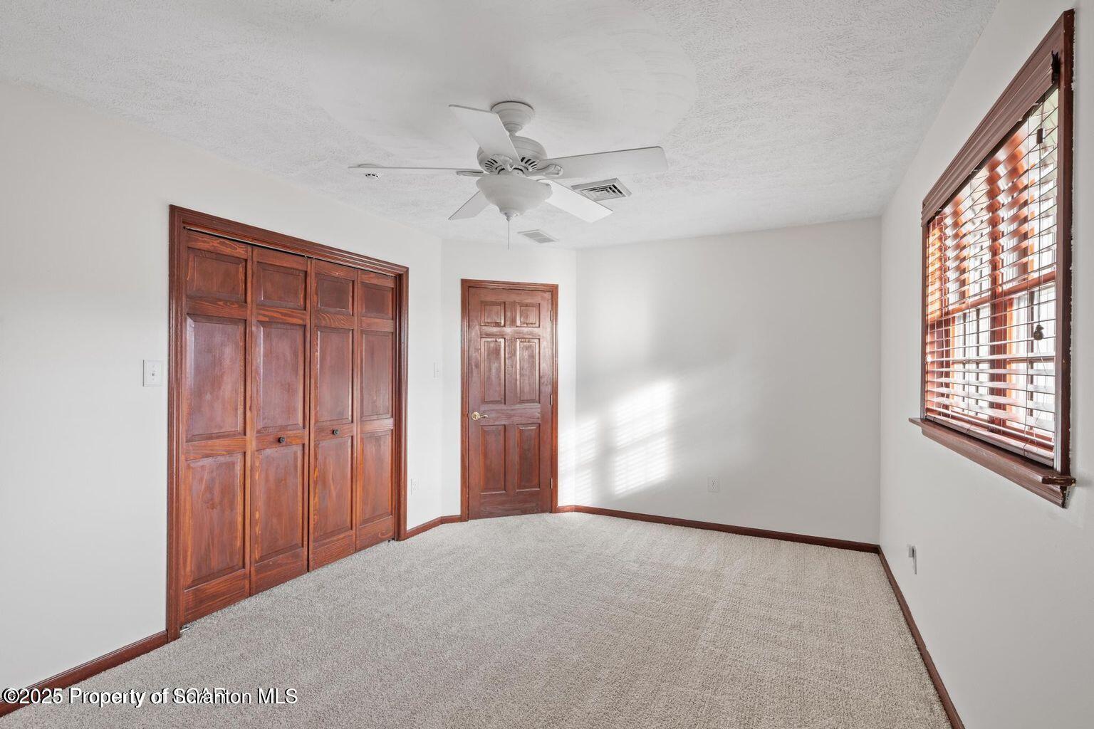 1266 Ryman Road Dallas, PA 18612 - Photo 21 of 73 an empty room with windows and fan