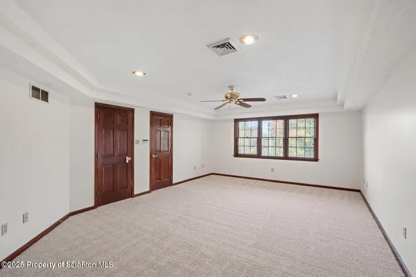 a view of empty room with floor to ceiling windows