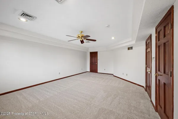 a living room with stainless steel appliances wooden floor and a fireplace
