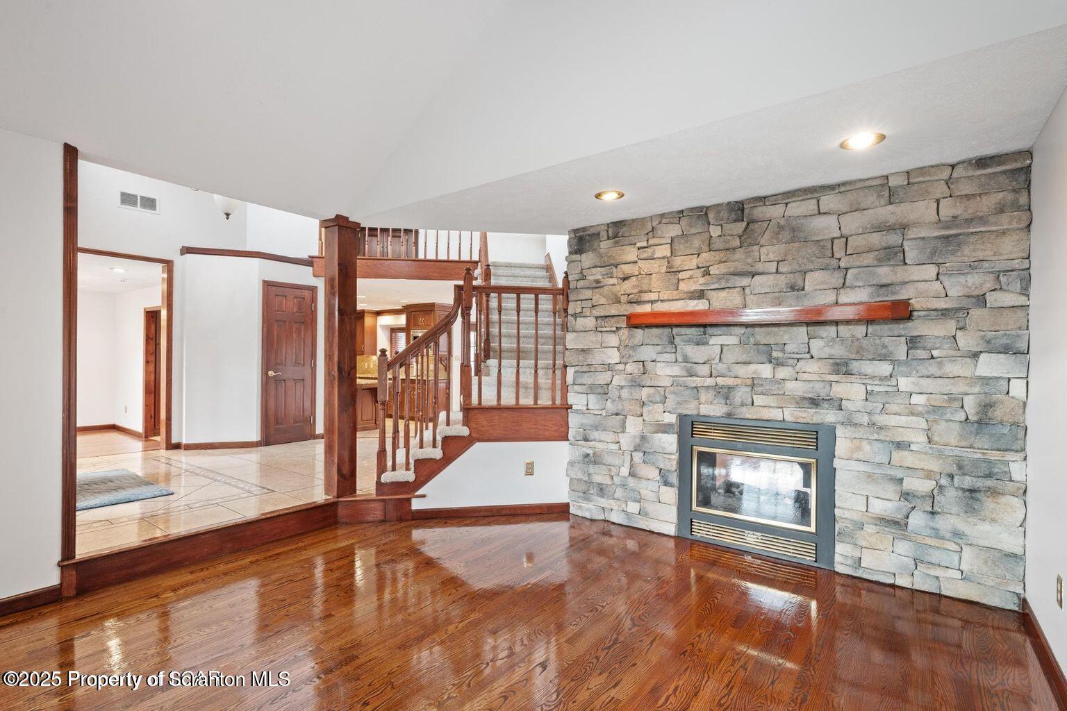 1266 Ryman Road Dallas, PA 18612 - Photo 37 of 73 a living room with stainless steel appliances wooden floor and a fireplace