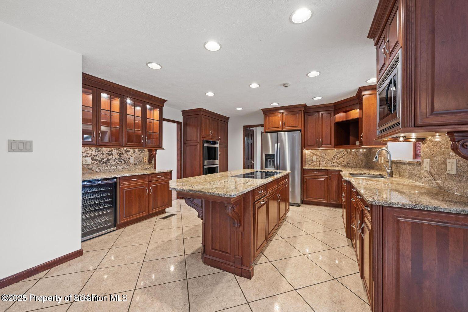 1266 Ryman Road Dallas, PA 18612 - Photo 40 of 73 a kitchen with stainless steel appliances granite countertop a stove oven and a refrigerator