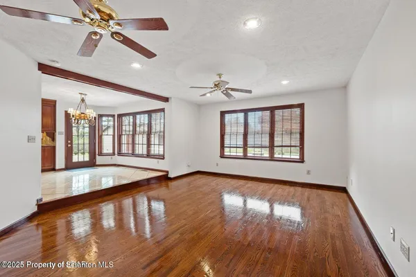 a view of an empty room with wooden floor
