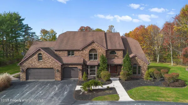 a view of a house with a swimming pool and a yard