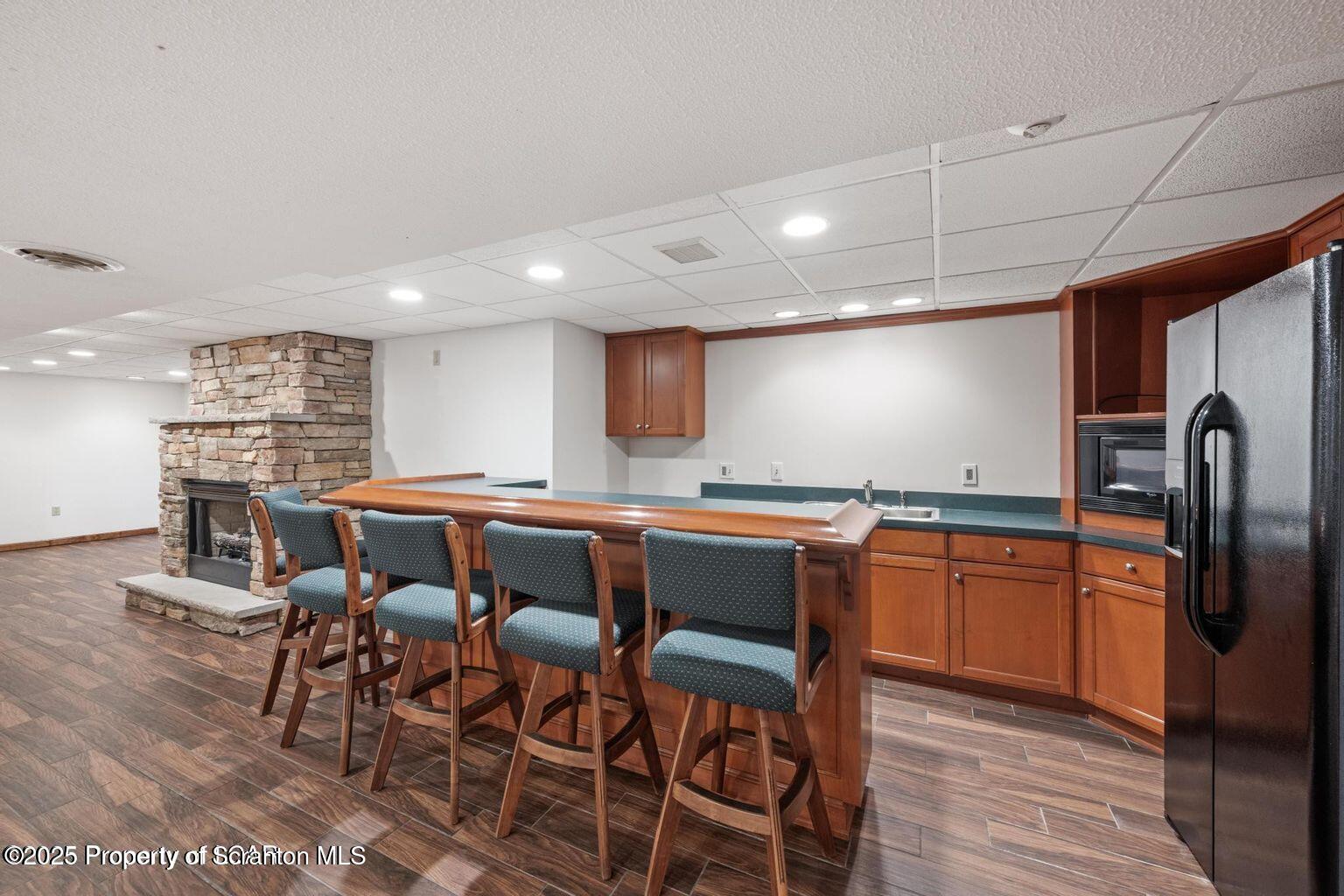 1266 Ryman Road Dallas, PA 18612 - Photo 61 of 73 a kitchen with stainless steel appliances granite countertop a table chairs sink and cabinets