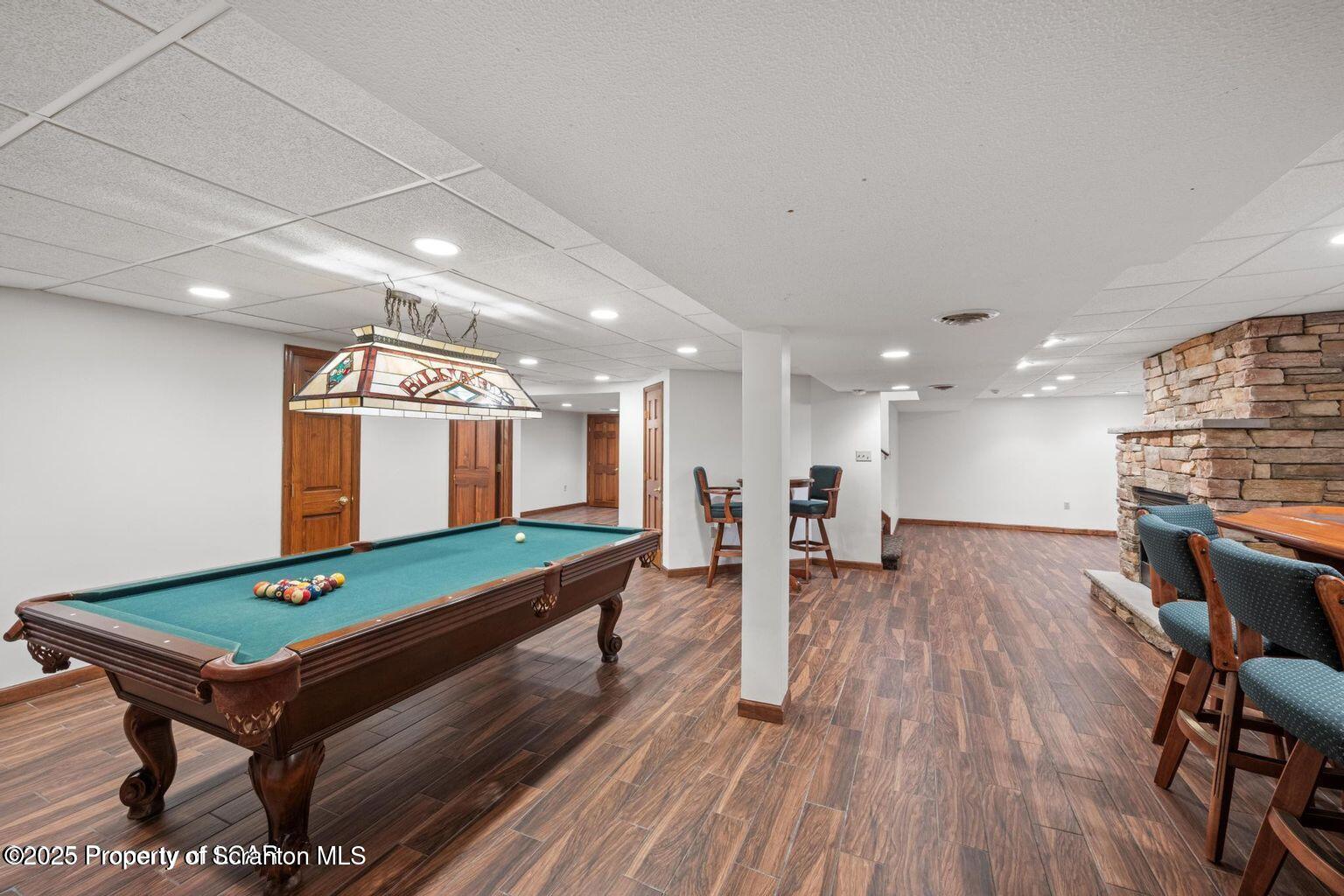 1266 Ryman Road Dallas, PA 18612 - Photo 62 of 73 a room with wooden floor pool table and chairs