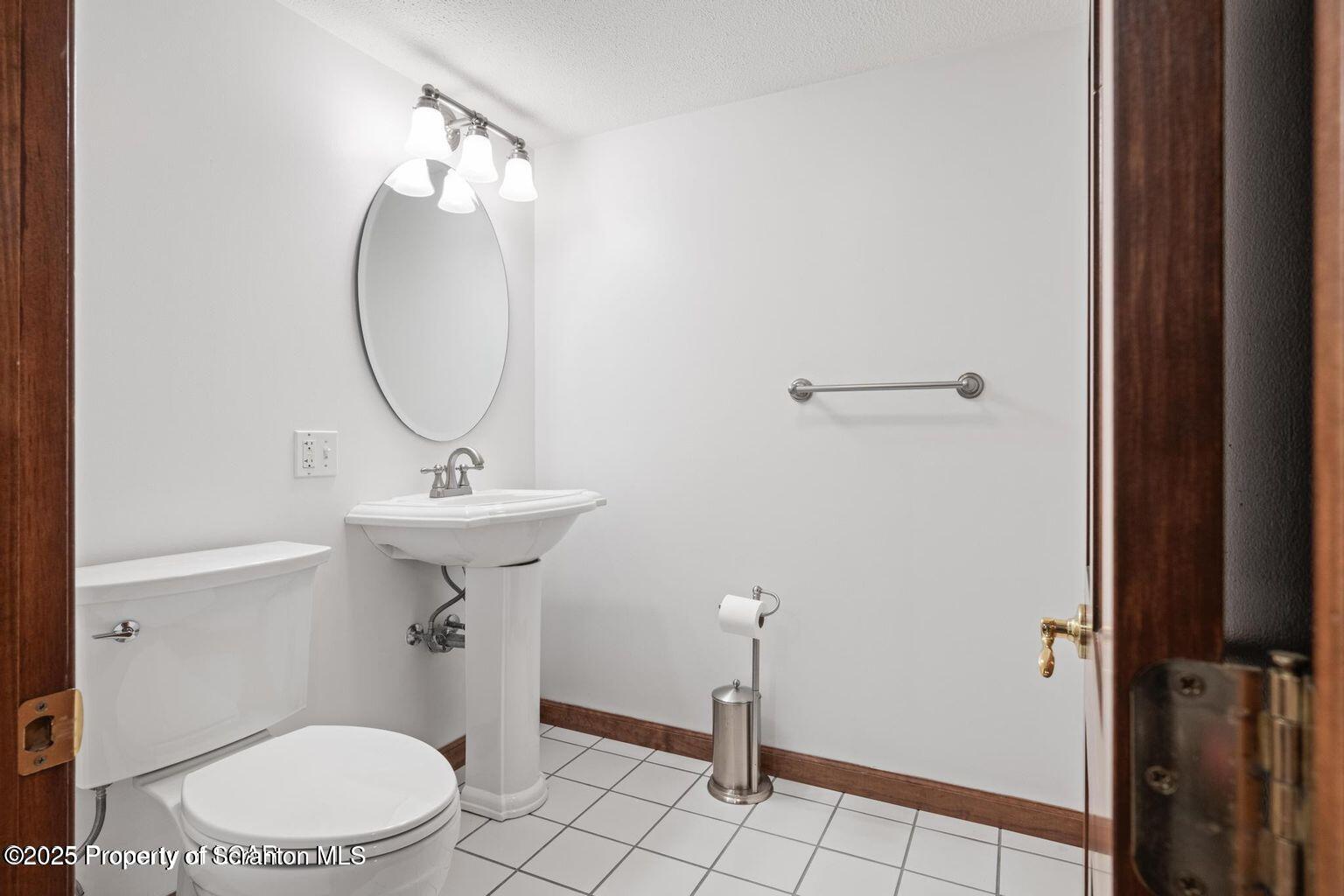 1266 Ryman Road Dallas, PA 18612 - Photo 64 of 73 a bathroom with a sink a toilet and a mirror