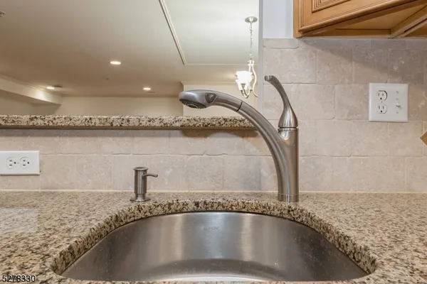 a view of a kitchen with a sink and wooden floor