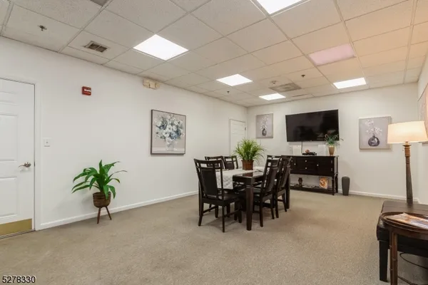a view of a livingroom with furniture and a flat screen tv