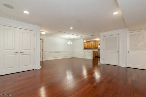 a view of empty room with wooden floor