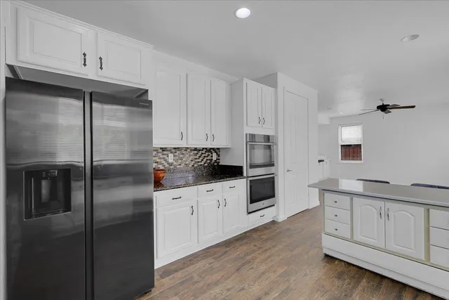 a kitchen with stainless steel appliances a refrigerator sink and cabinets
