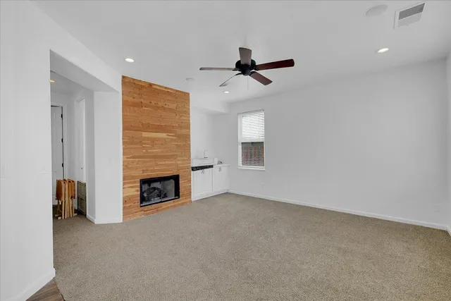 a view of a livingroom with a fireplace and window