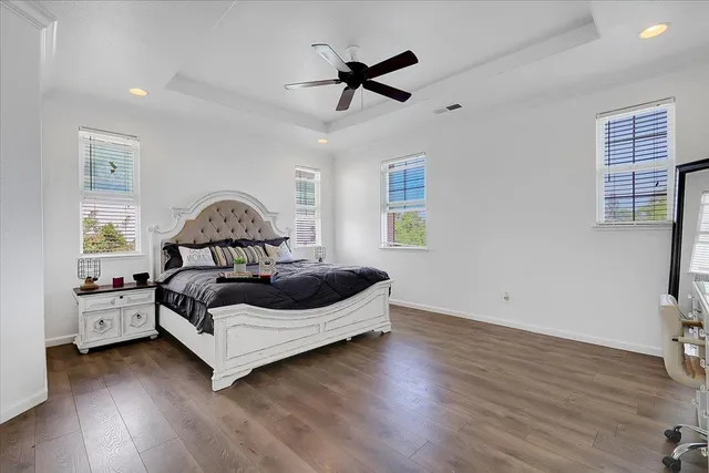 a white bed sitting in a room next to a window
