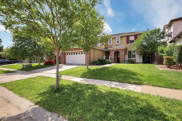 a sign board with a yard and fence