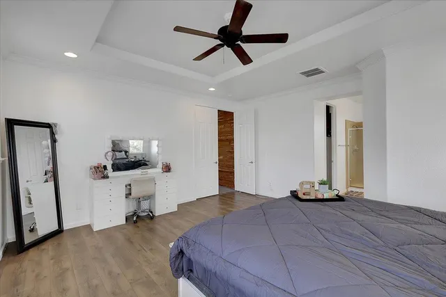 a bedroom with furniture and a flat screen tv