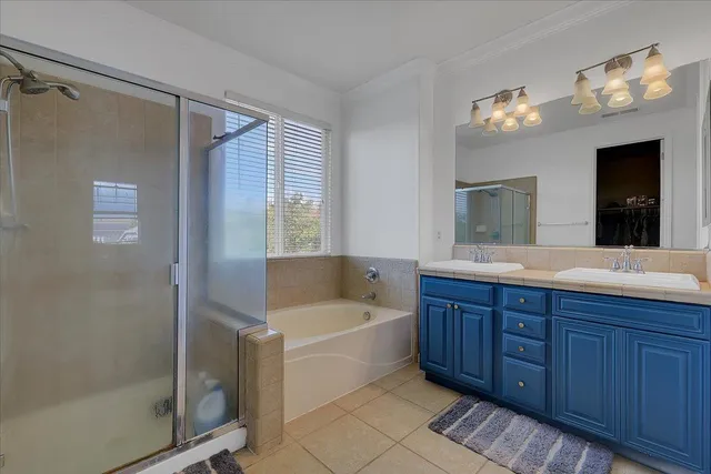 a bathroom with a tub a sink and mirror