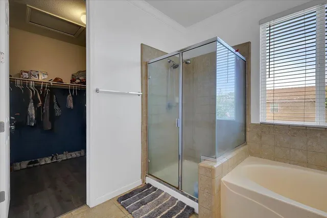 a bathroom with a shower and a tub