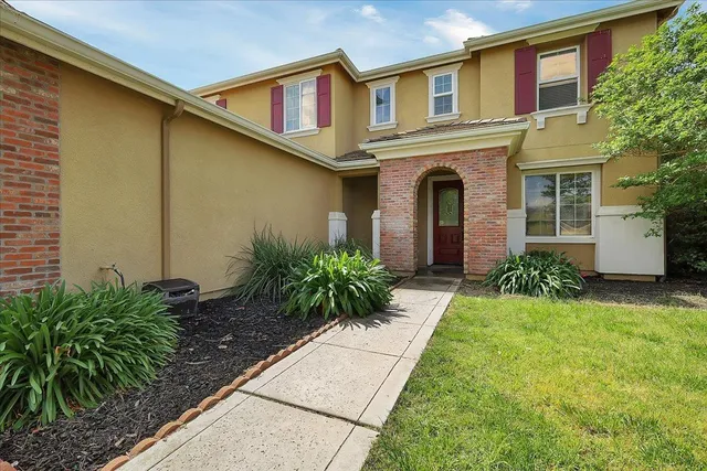 a front view of a house with garden