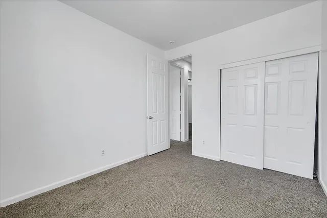 a view of a backyard with wooden fence