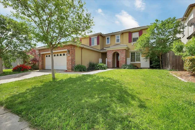 a front view of house with yard and green space