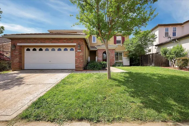 a front view of house with yard and green space