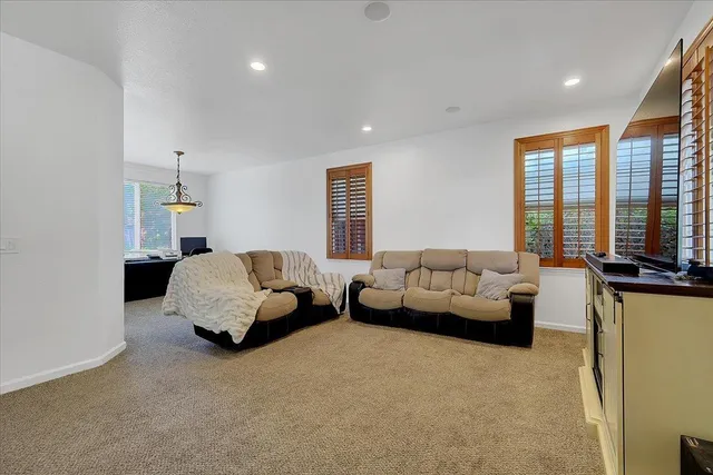 a living room with furniture and large windows