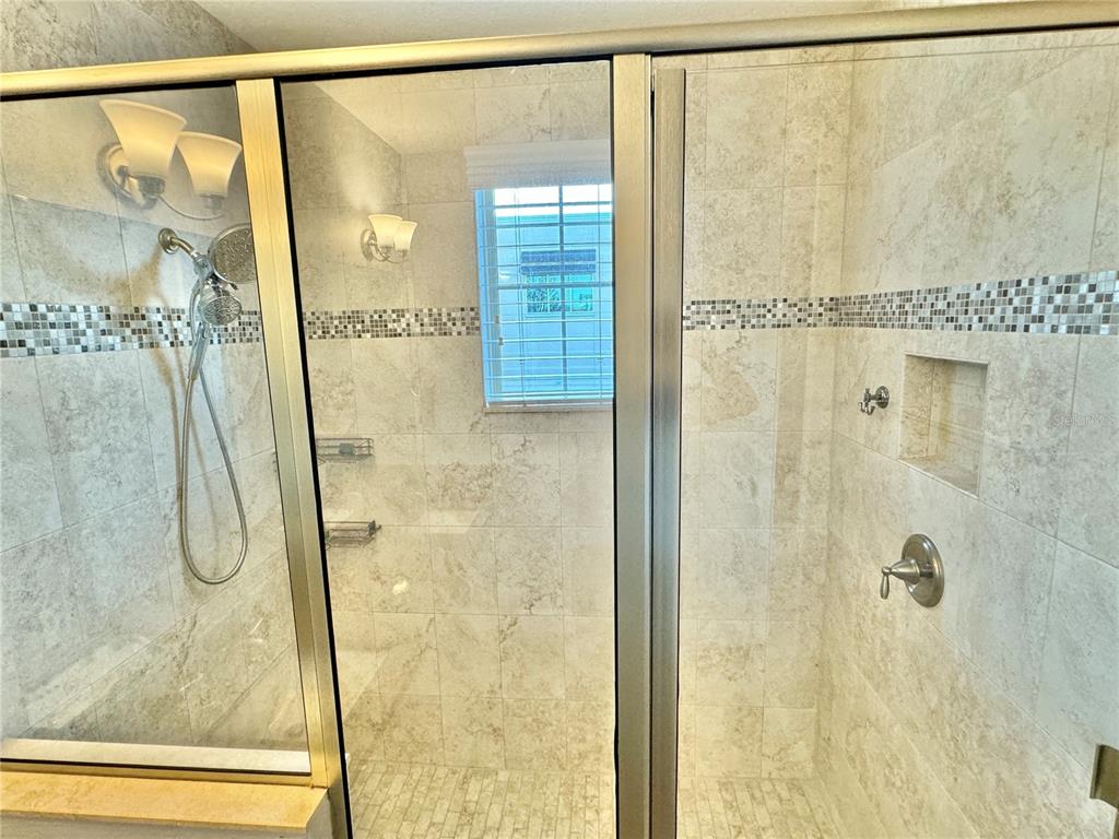 9799 Winnington Street Orlando, FL 32832 - Photo 11 of 78 a bathroom with a shower