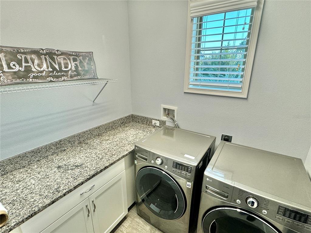 9799 Winnington Street Orlando, FL 32832 - Photo 15 of 78 a utility room with dryer and washer