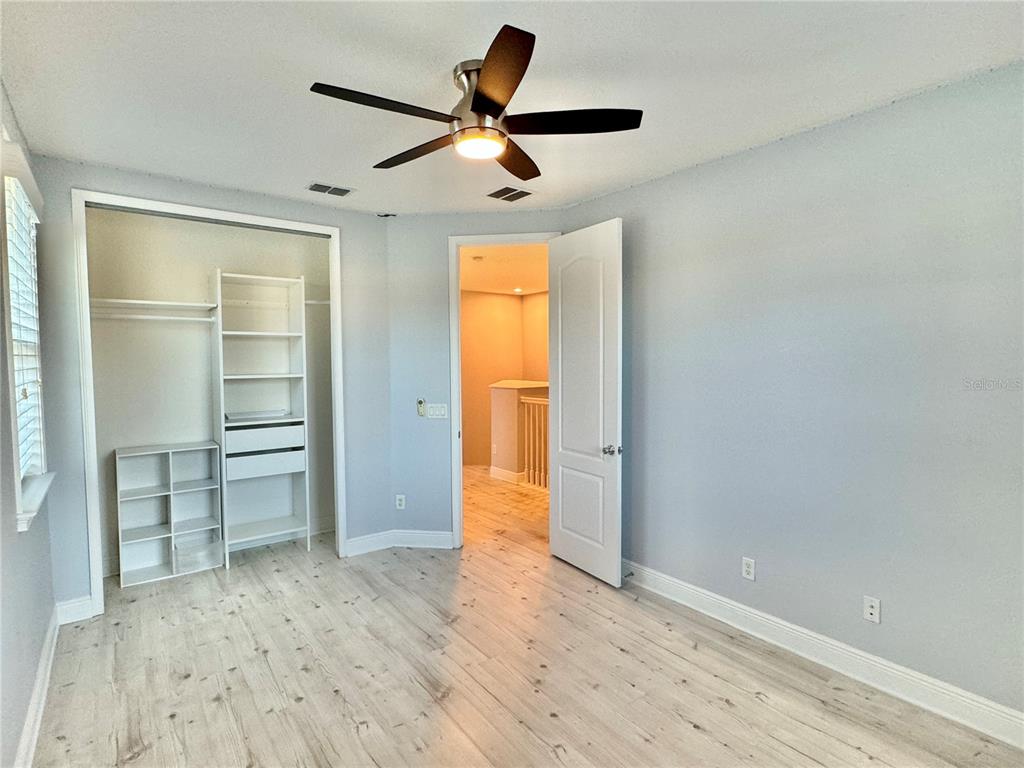 9799 Winnington Street Orlando, FL 32832 - Photo 19 of 78 an empty room with a window and a ceiling fan