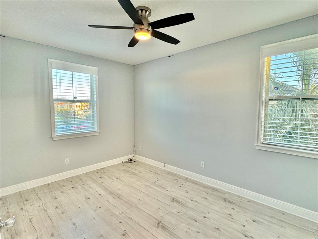 9799 Winnington Street Orlando, FL 32832 - Photo 21 of 78 a view of empty room with wooden floor and fan