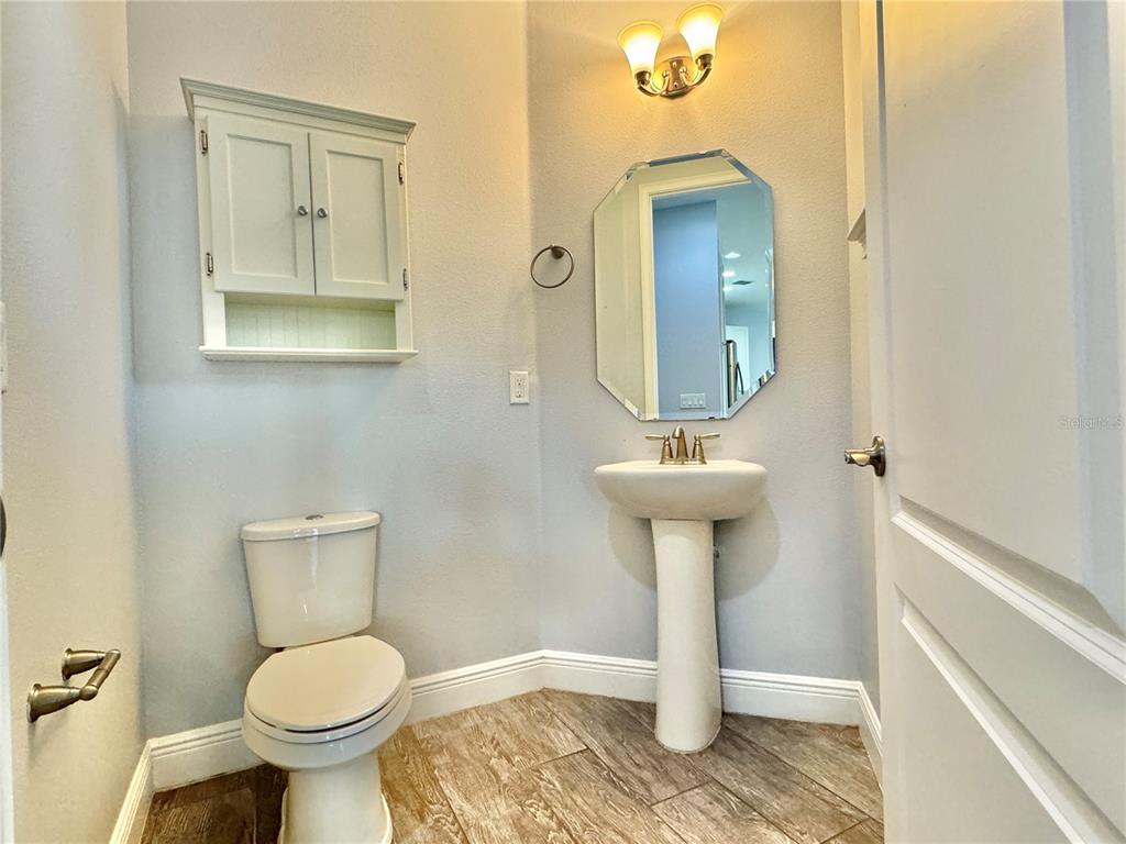 9799 Winnington Street Orlando, FL 32832 - Photo 28 of 78 a bathroom with a toilet sink and mirror