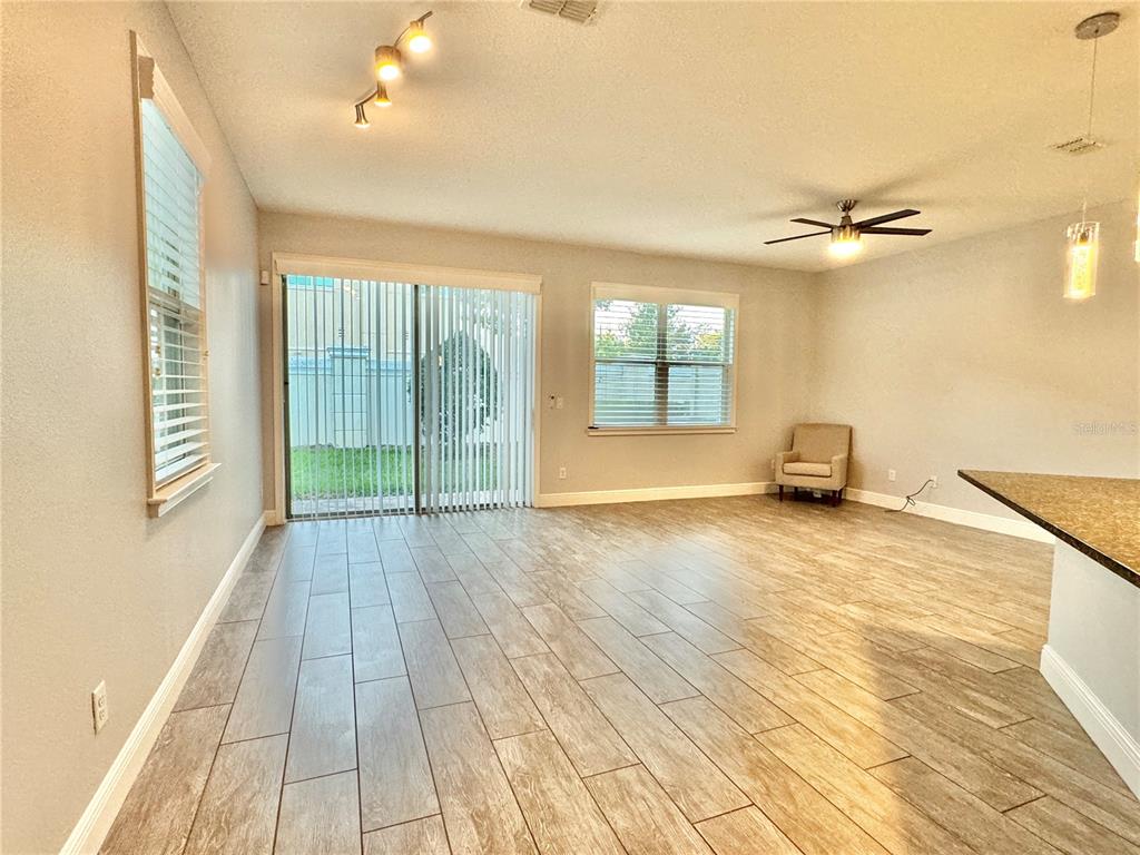 9799 Winnington Street Orlando, FL 32832 - Photo 32 of 78 wooden floor in an empty room with a window