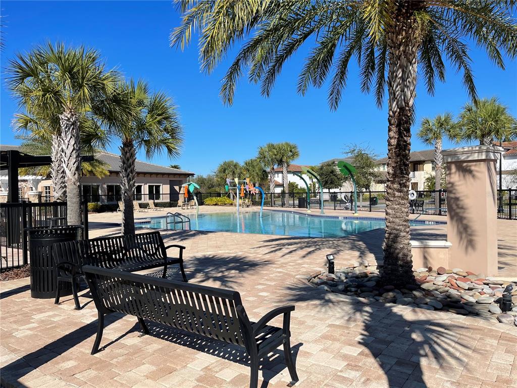 9799 Winnington Street Orlando, FL 32832 - Photo 54 of 78 a view of a swimming pool with a table and chairs
