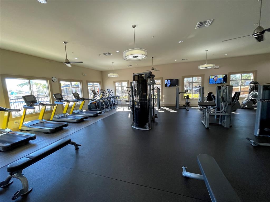 9799 Winnington Street Orlando, FL 32832 - Photo 61 of 78 a view of a room with gym equipment and a view of living room