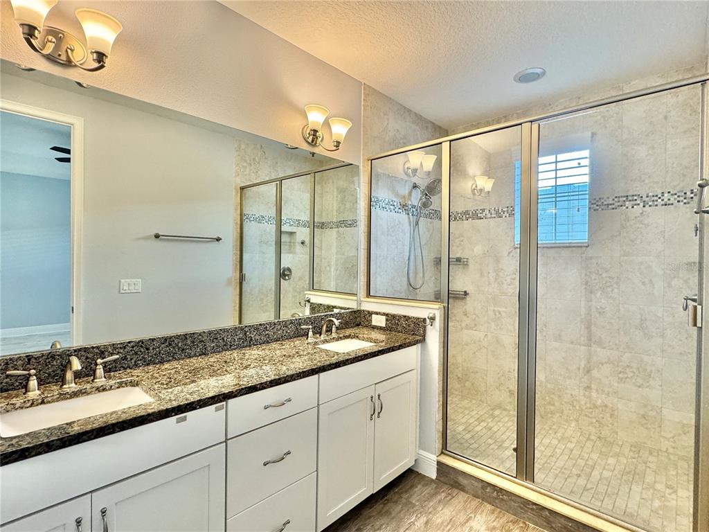 9799 Winnington Street Orlando, FL 32832 - Photo 9 of 78 a bathroom with a granite countertop sink mirror and double