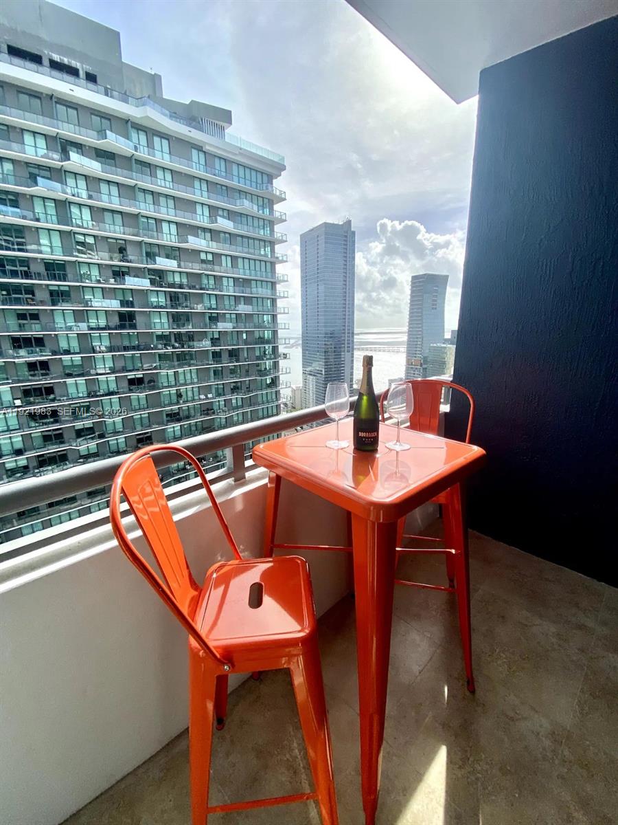 60 Southwest 13th Street, Unit 4414 Miami, FL 33130 - Photo 12 of 21 a blue table sitting next to a blue white chair