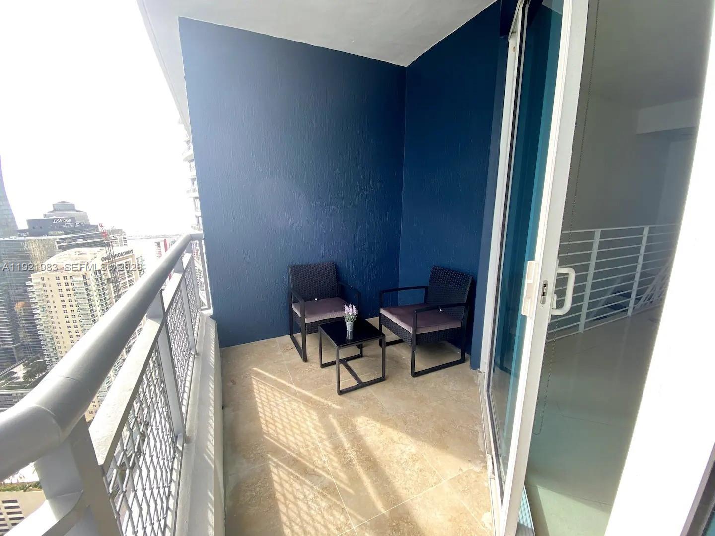 60 Southwest 13th Street, Unit 4414 Miami, FL 33130 - Photo 7 of 21 a balcony view with a couch and wooden floor