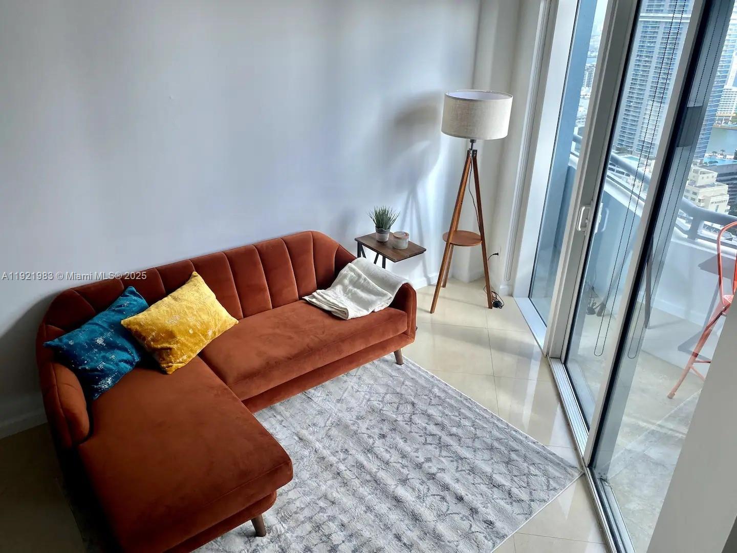 60 Southwest 13th Street, Unit 4414 Miami, FL 33130 - Photo 8 of 22 a living room with furniture and a rug