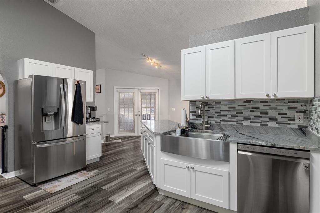 10918 Midland Bridge Road Hudson, FL 34667 - Photo 11 of 42 a kitchen with a refrigerator sink and cabinets