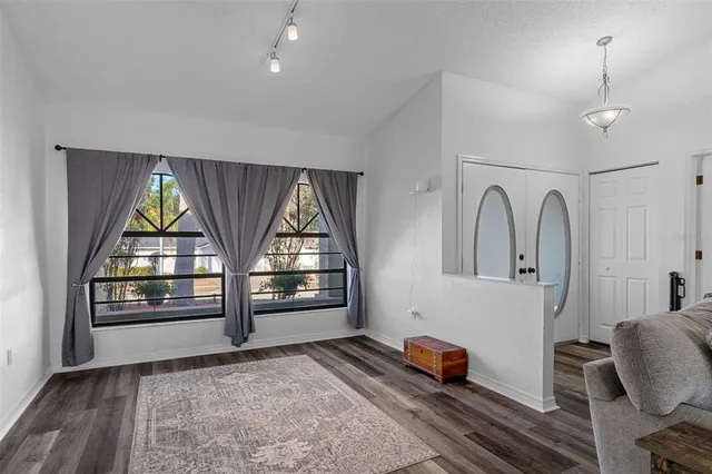 a view of workspace with wooden floor and windows