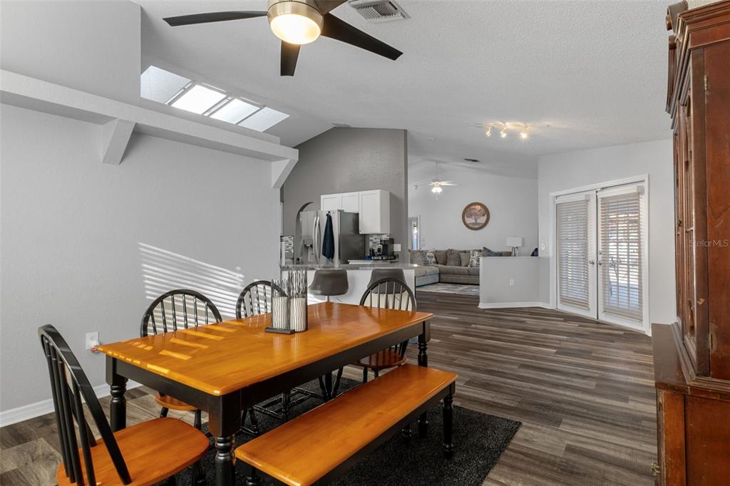 10918 Midland Bridge Road Hudson, FL 34667 - Photo 16 of 42 a living room with furniture a table and wooden floor