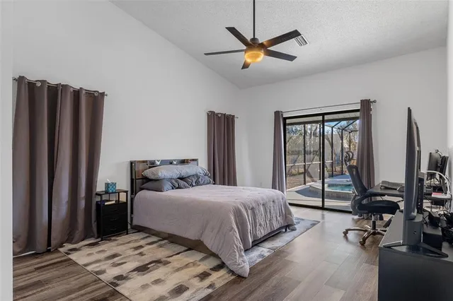 a bedroom with a large bed and a chandelier