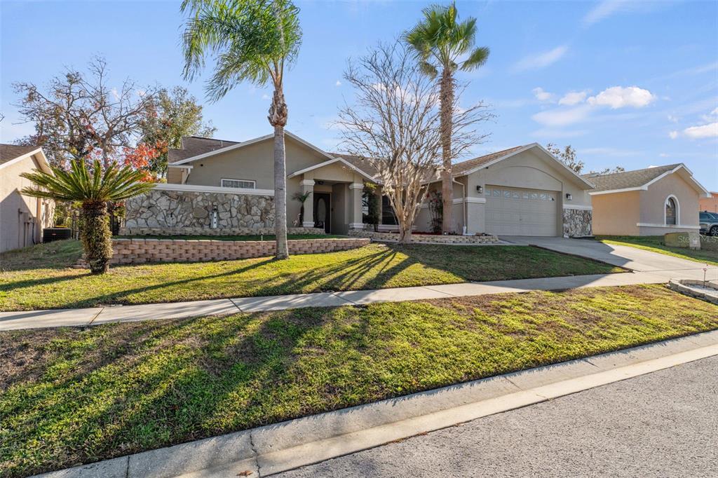 10918 Midland Bridge Road Hudson, FL 34667 - Photo 3 of 42 a view of pool with a yard and palm trees
