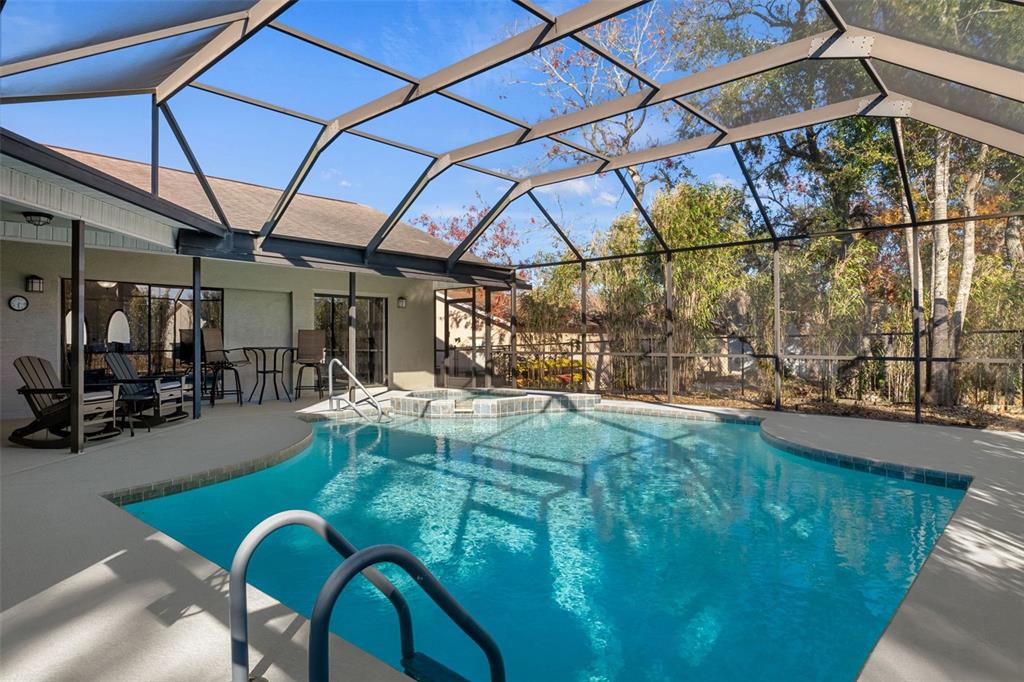 10918 Midland Bridge Road Hudson, FL 34667 - Photo 31 of 42 a view of a swimming pool with a patio and a yard