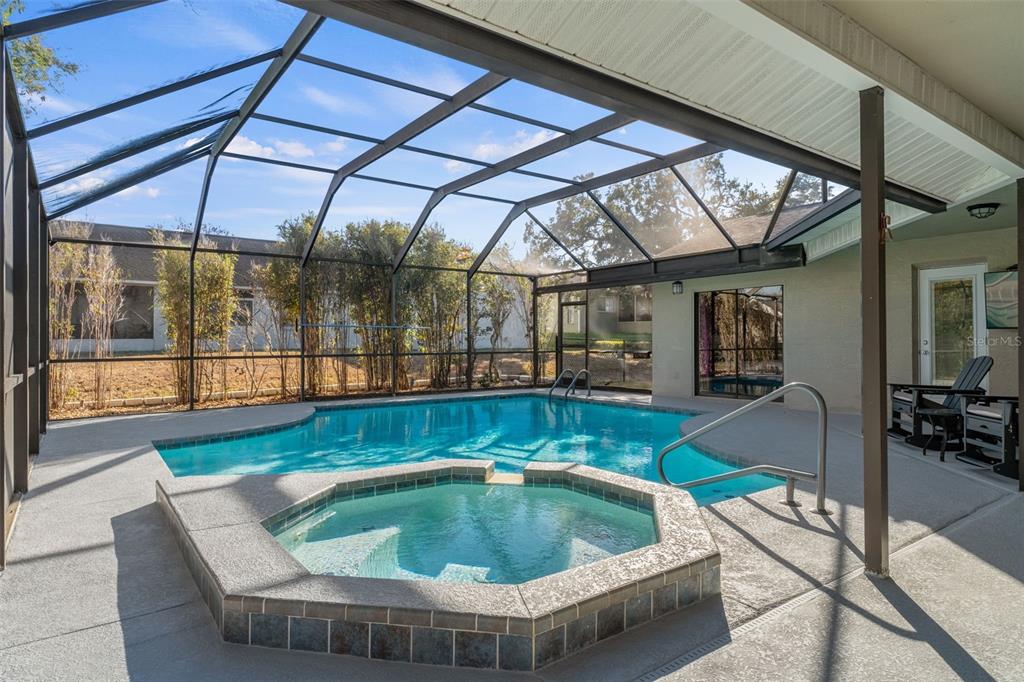 10918 Midland Bridge Road Hudson, FL 34667 - Photo 33 of 42 a table and chairs in a small pool