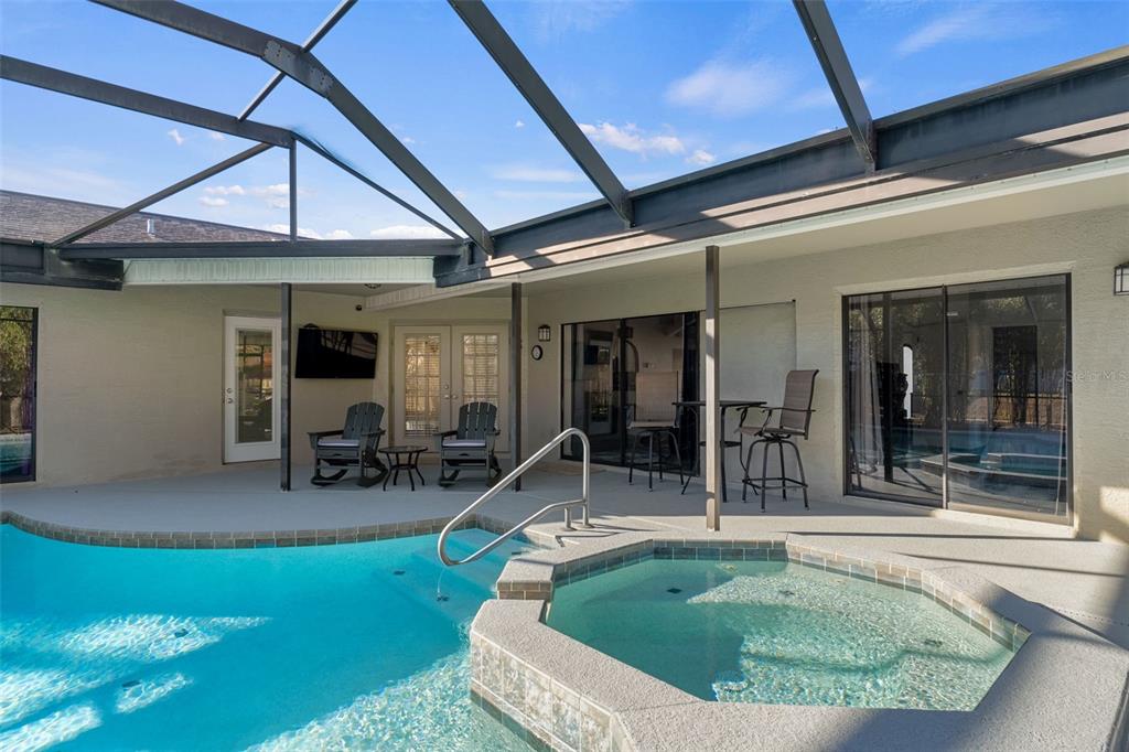 10918 Midland Bridge Road Hudson, FL 34667 - Photo 34 of 42 a view of a house with swimming pool and sitting area