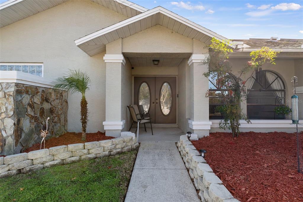 10918 Midland Bridge Road Hudson, FL 34667 - Photo 5 of 42 a front view of a house with garden