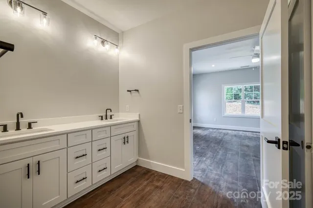 a bathroom with a double vanity sink and mirror